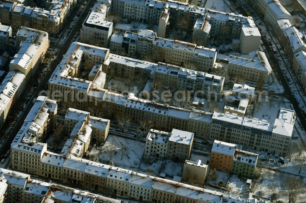 Berlin from the bird's eye view: Winterly snowy residential area of a multi-family house settlement Strassen Schreiberhauer Strasse , Pfarrstrasse , Kaskelstrasse und Spittastrasse in Berlin in Germany