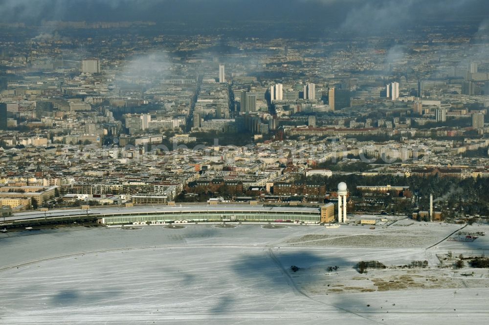 Berlin from above - Wintry snowy dispatch building and terminals on the premises of the formerly airport in the district Tempelhof in Berlin, Germany