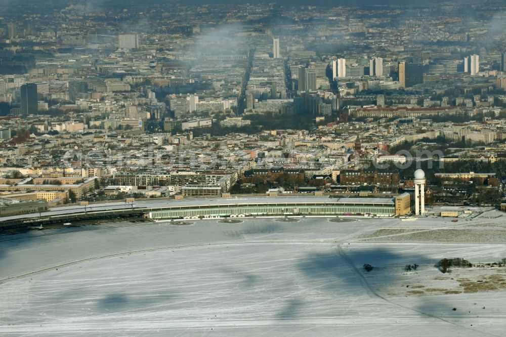 Berlin from the bird's eye view: Wintry snowy dispatch building and terminals on the premises of the formerly airport in the district Tempelhof in Berlin, Germany