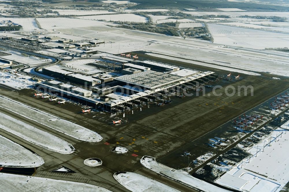 Schönefeld from above - Wintry snowy dispatch building and terminals on the premises of the airport BER in Schoenefeld in the state Brandenburg