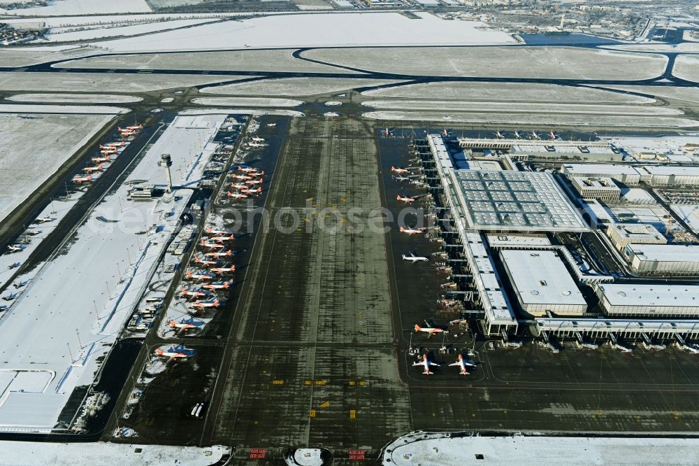 Schönefeld from above - Wintry snowy dispatch building and terminals on the premises of the airport BER in Schoenefeld in the state Brandenburg