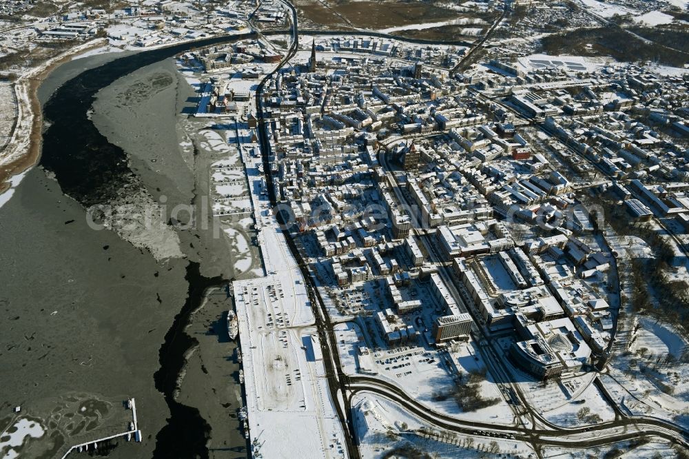 Rostock from the bird's eye view: Wintry snowy old Town area and city center on shore of Unterwarnow in Rostock in the state Mecklenburg - Western Pomerania, Germany