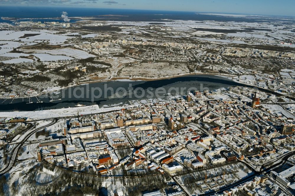 Rostock from the bird's eye view: Wintry snowy old Town area and city center on shore of Unterwarnow in Rostock in the state Mecklenburg - Western Pomerania, Germany