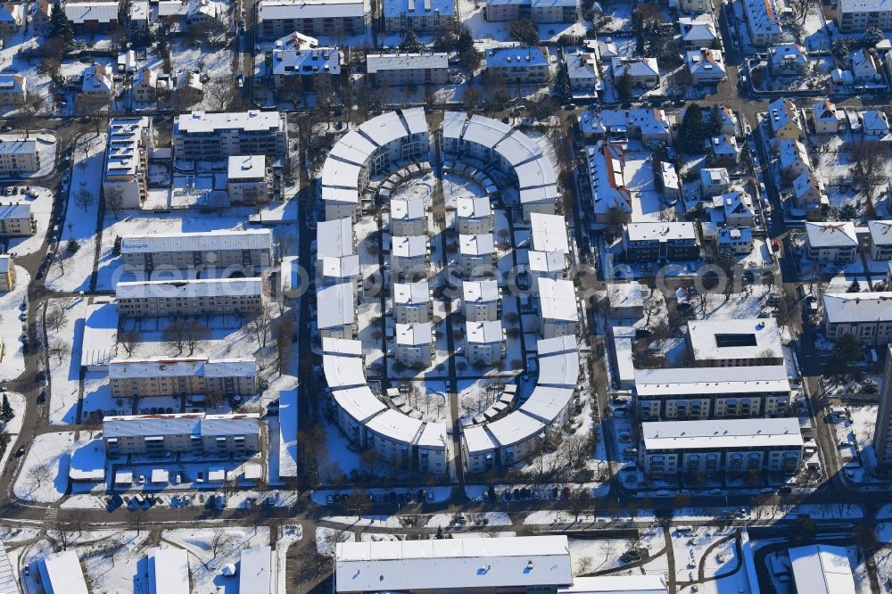 Aerial photograph Lörrach - Wintry snowy residential development on the site of the former stadium in Loerrach in Baden-Wuerttemberg. The geometry of the stadium was maintained for the arrangement of the houses and blocks