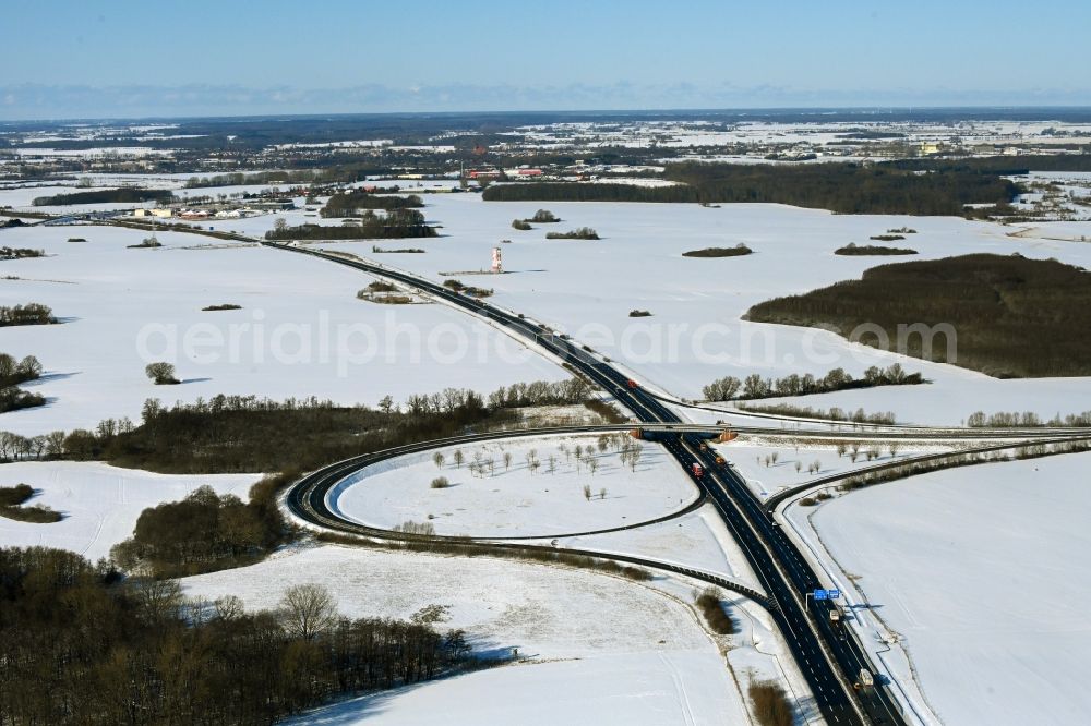 Aerial image Süderholz - Wintry snowy route and lanes in the course of the exit and access of the motorway junction of the BAB A20 - E251 Abfahrt Stralsund in Suederholz in the state Mecklenburg - Western Pomerania, Germany