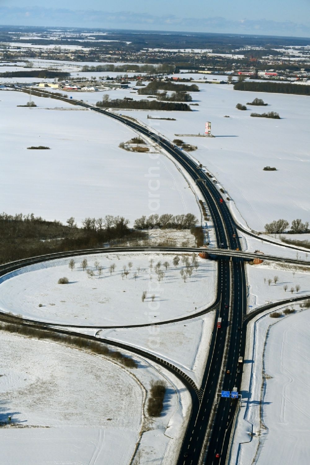 Süderholz from the bird's eye view: Wintry snowy route and lanes in the course of the exit and access of the motorway junction of the BAB A20 - E251 Abfahrt Stralsund in Suederholz in the state Mecklenburg - Western Pomerania, Germany