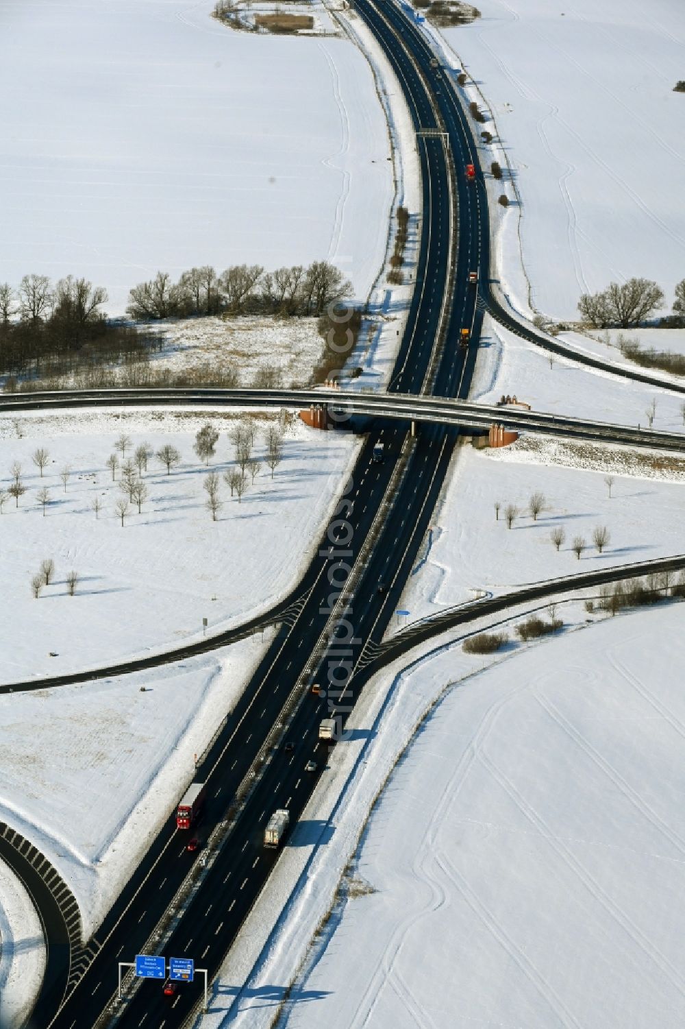 Aerial image Süderholz - Wintry snowy route and lanes in the course of the exit and access of the motorway junction of the BAB A20 - E251 Abfahrt Stralsund in Suederholz in the state Mecklenburg - Western Pomerania, Germany