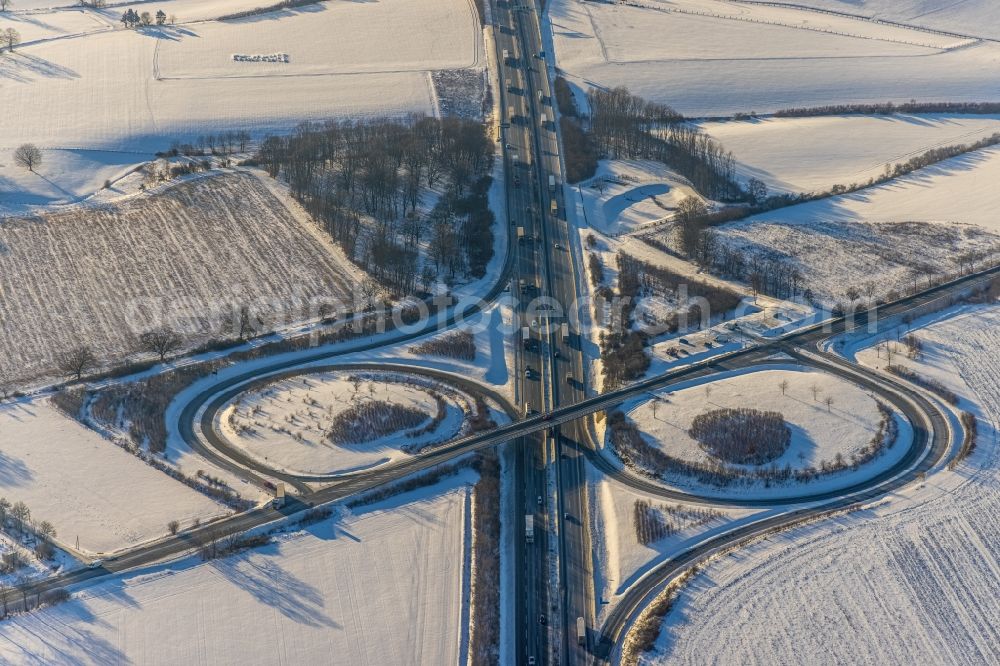 Werl from above - Wintry snowy routing and traffic lanes during the highway exit and access the motorway A 44 Werl-Sued in the district Westoennen in Werl at Ruhrgebiet in the state North Rhine-Westphalia, Germany