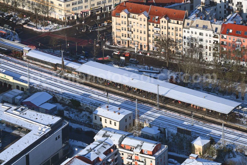 Aerial image Berlin - Wintry snowy station building and track systems of the S-Bahn station on street Bahnhofstrasse in the district Koepenick in Berlin, Germany