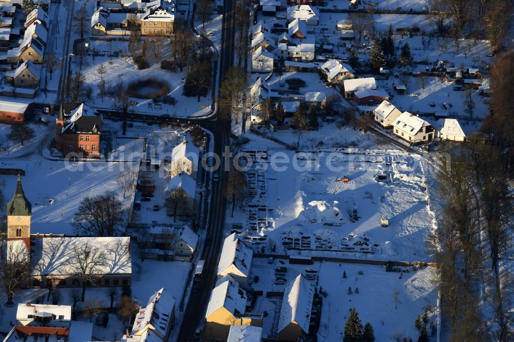 Altlandsberg from the bird's eye view: Wintry snowy Construction site with development works and embankments works and archaeological digging work in Altlandsberg in the state Brandenburg