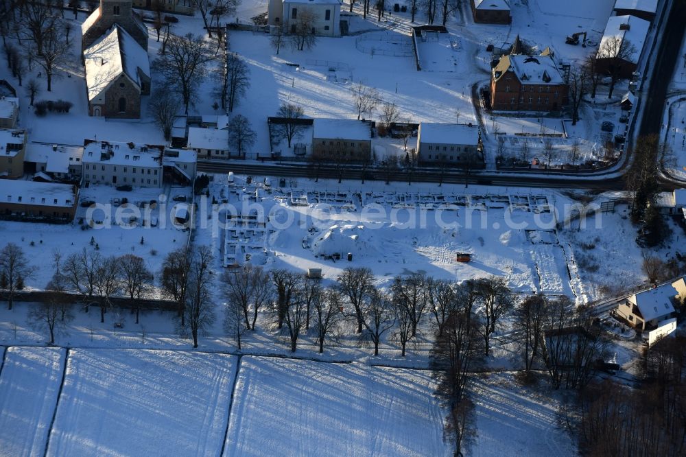 Aerial photograph Altlandsberg - Wintry snowy Construction site with development works and embankments works and archaeological digging work in Altlandsberg in the state Brandenburg