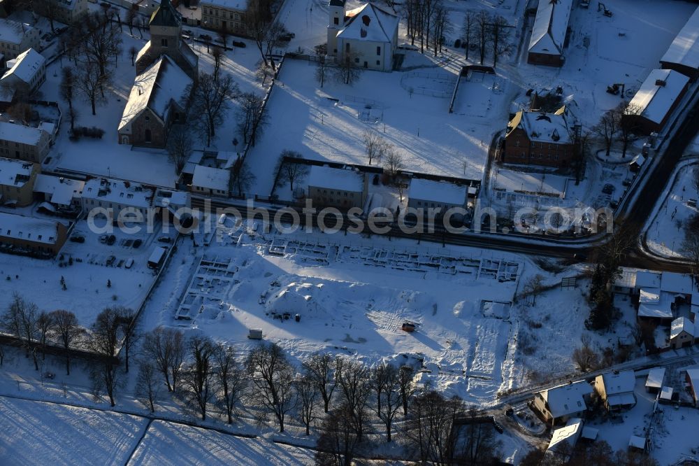 Aerial photograph Altlandsberg - Wintry snowy Construction site with development works and embankments works and archaeological digging work in Altlandsberg in the state Brandenburg