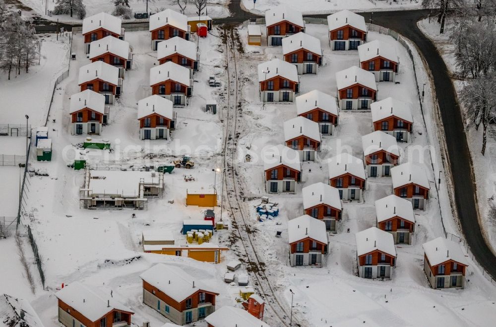 Winterberg from above - Wintry snowy construction site of holiday house plant of the park UplandParcs in Winterberg at Sauerland in the state North Rhine-Westphalia, Germany