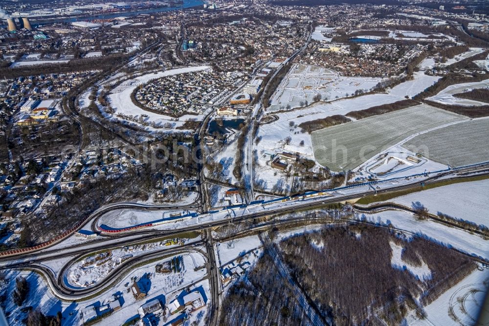 Aerial image Ungelsheim - Wintry snowy construction site of ruting and traffic lanes during the exit federal highway B288 in Ungelsheim at Ruhrgebiet in the state North Rhine-Westphalia, Germany