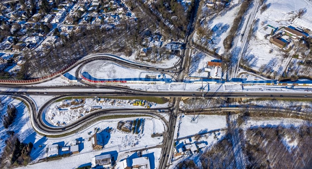 Aerial photograph Ungelsheim - Wintry snowy construction site of ruting and traffic lanes during the exit federal highway B288 in Ungelsheim at Ruhrgebiet in the state North Rhine-Westphalia, Germany