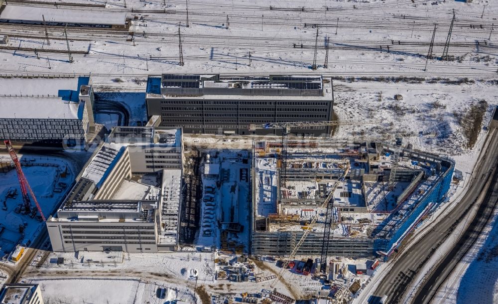 Duisburg from above - Wintry snowy construction site to build a new office and commercial building Koloniestrasse - Wuhanstrasse in Duisburg in the state North Rhine-Westphalia, Germany