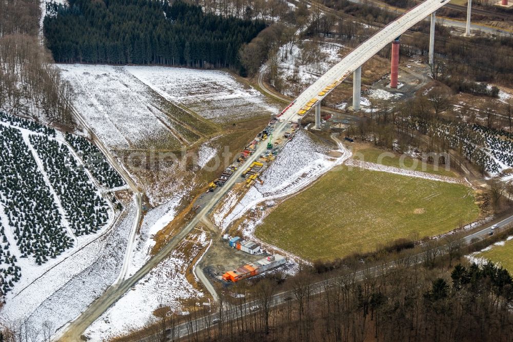 Nuttlar from the bird's eye view: Wintry snowy New construction of the Highway - motorway bridge of the A46 Talbruecke Schormecke - Schormecke Bruecke of BAB A46 in Nuttlar in the state North Rhine-Westphalia, Germany