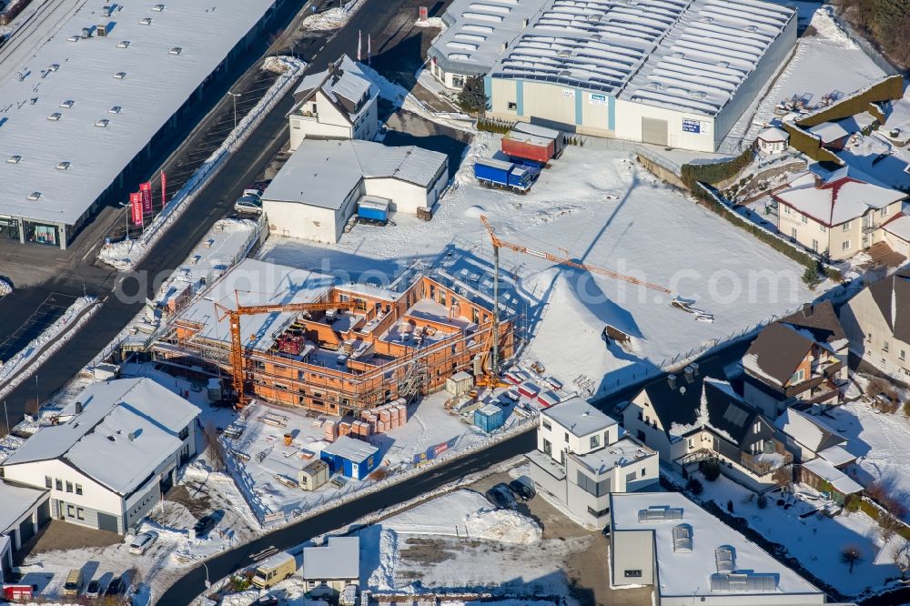 Aerial image Brilon - Wintry snowy Construction site to build a new office and commercial building Freiladestrasse - Papestrasse durch die Eickmann Bauunternehmung GmbH in Brilon in the state North Rhine-Westphalia