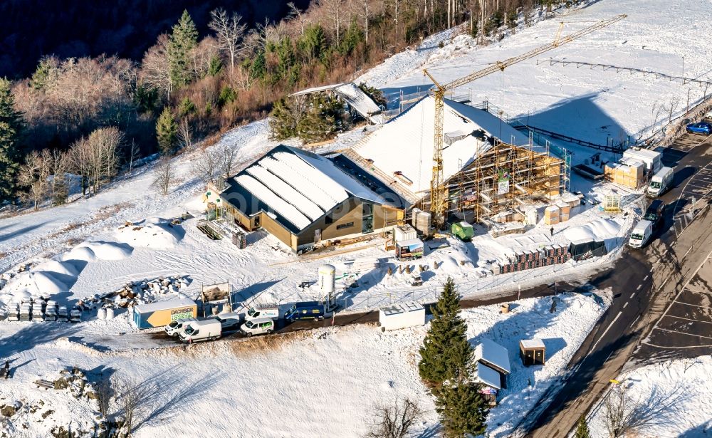 Sankt Peter from the bird's eye view: Wintry snowy new construction site the hotel complex Kandelhotel on Berg Kandel in Sankt Peter in the state Baden-Wuerttemberg, Germany