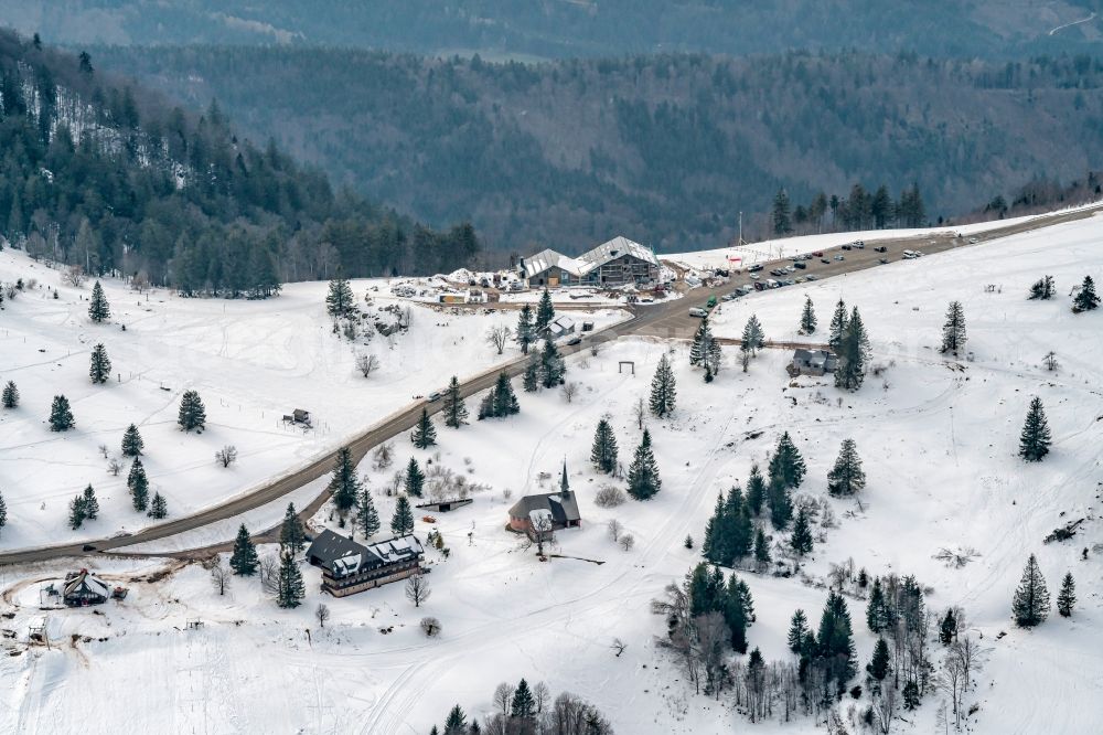 Sankt Peter from the bird's eye view: Wintry snowy new construction site the hotel complex Kandelhotel on Berg Kandel in Sankt Peter in the state Baden-Wuerttemberg, Germany