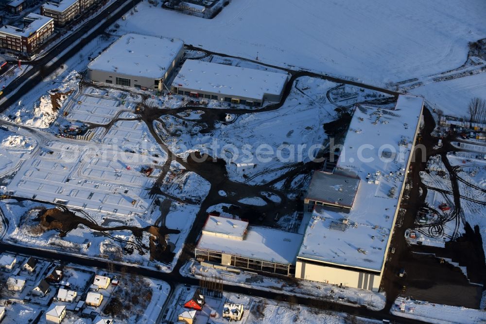 Aerial photograph Berlin - Wintry snowy construction site for the new building home-center of the Porta-Group at Pilgramer street in the district Mahlsdorf in Berlin