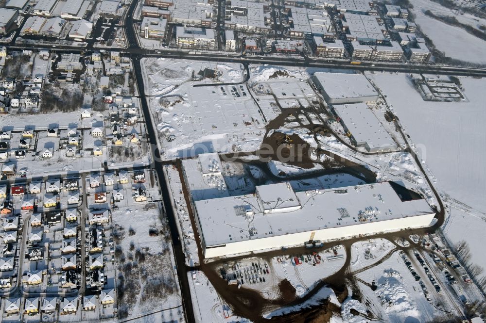 Aerial photograph Berlin - Wintry snowy construction site for the new building home-center of the Porta-Group at Pilgramer street in the district Mahlsdorf in Berlin