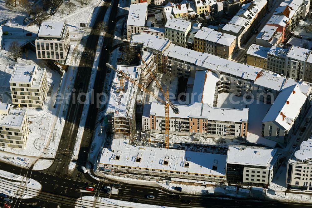 Rostock from the bird's eye view: Wintry snowy construction site to build a new multi-family residential complex of Bouwfonds IM Deutschland GmbH Am Voegenteich - August-Bebel-Strasse in Rostock in the state Mecklenburg - Western Pomerania, Germany