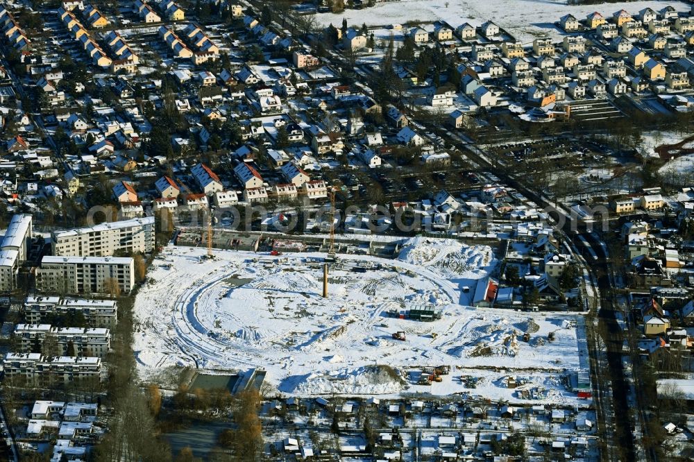 Berlin from the bird's eye view: Wintry snowy construction site to build a new multi-family residential complex HUGOS of Bonava Deutschland GmbH on Britzer Strasse in the district Mariendorf in Berlin, Germany