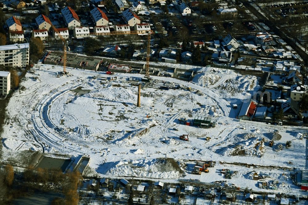 Aerial image Berlin - Wintry snowy construction site to build a new multi-family residential complex HUGOS of Bonava Deutschland GmbH on Britzer Strasse in the district Mariendorf in Berlin, Germany