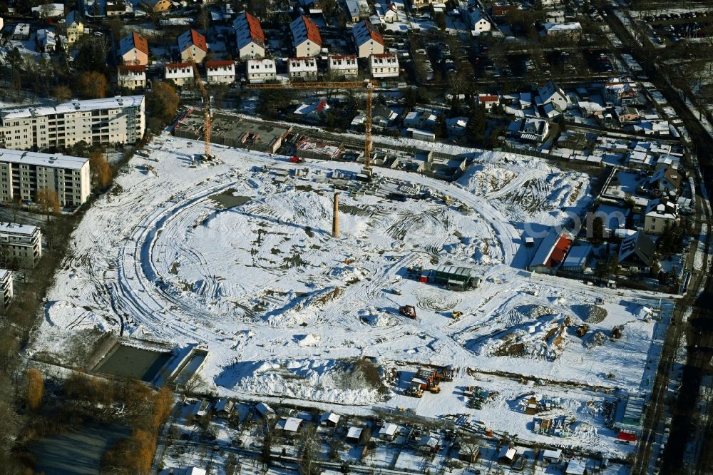 Aerial photograph Berlin - Wintry snowy construction site to build a new multi-family residential complex HUGOS of Bonava Deutschland GmbH on Britzer Strasse in the district Mariendorf in Berlin, Germany