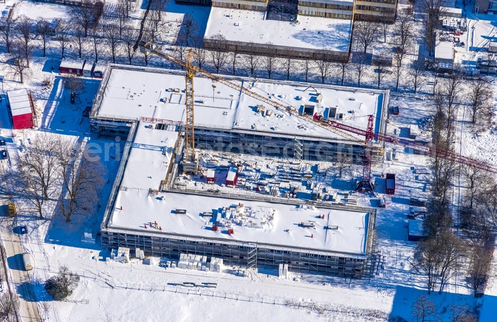 Aerial image Unna - Wintry snowy new construction site of the school building with Continuing Education Center on Bildungscampus Unna in the district Alte Heide in Unna at Ruhrgebiet in the state North Rhine-Westphalia, Germany