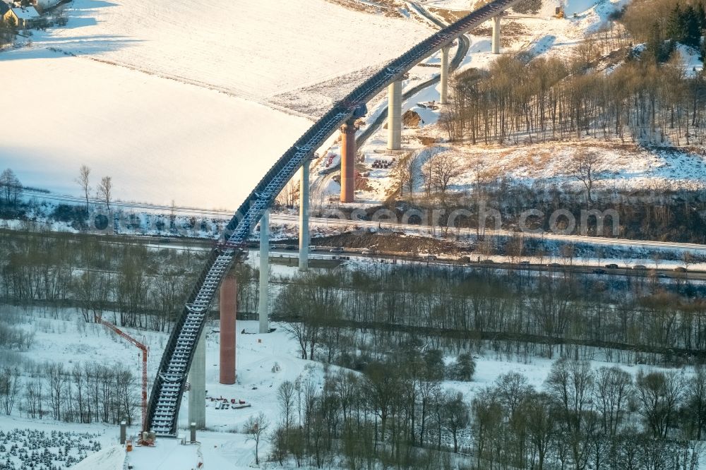 Olsberg from the bird's eye view: Wintry snowy Construction of road bridge Autobahn A46 der Bundestrasse B7 in Olsberg in the state North Rhine-Westphalia