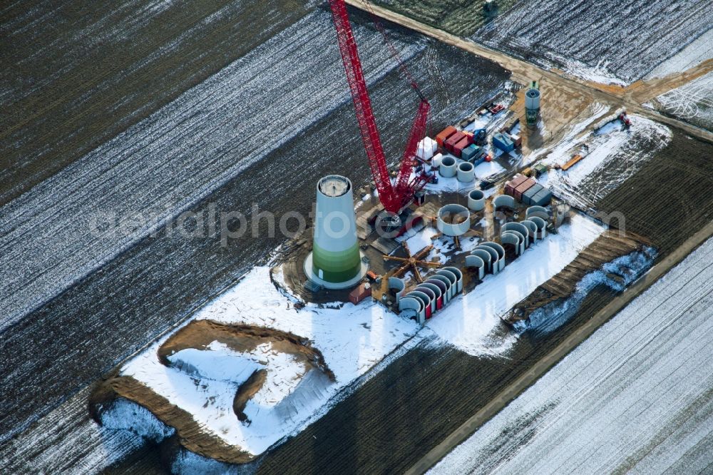 Hatzenbühl from above - Wintry snowy Construction site for wind turbine installation in Hatzenbuehl in the state Rhineland-Palatinate, Germany