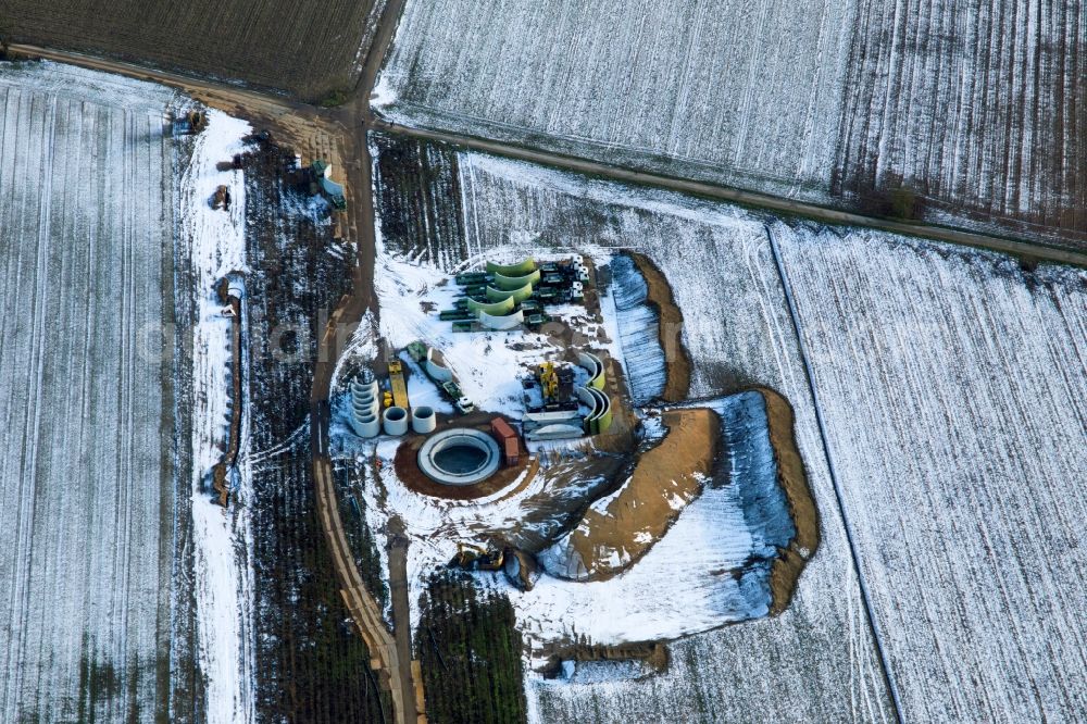 Hatzenbühl from the bird's eye view: Wintry snowy Construction site for wind turbine installation in Hatzenbuehl in the state Rhineland-Palatinate, Germany