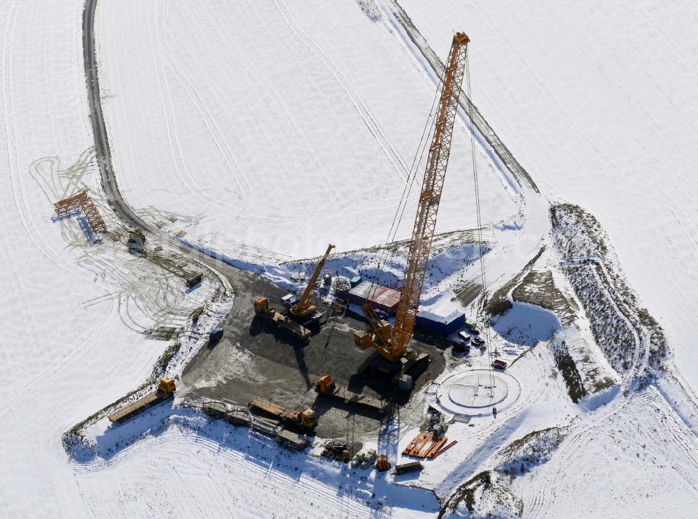 Aerial photograph Jühnde - Wintry snowy Construction site for wind turbine installation in Juehnde in the state Lower Saxony, Germany