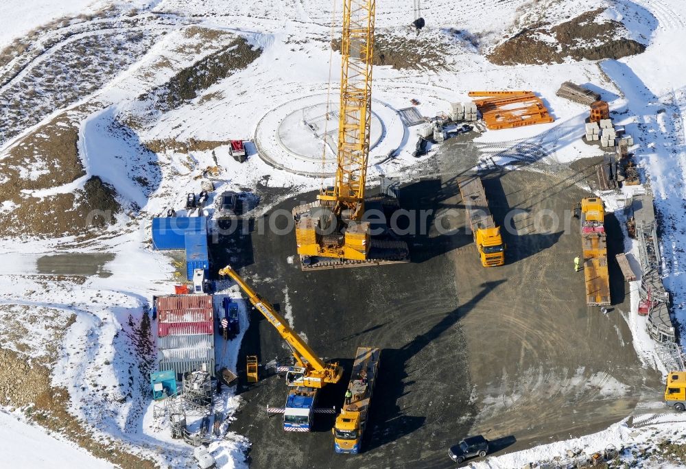 Jühnde from above - Wintry snowy Construction site for wind turbine installation in Juehnde in the state Lower Saxony, Germany