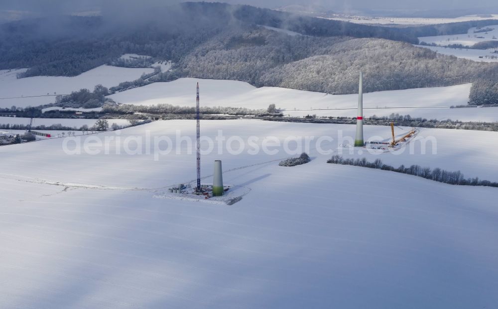 Witzenhausen from the bird's eye view: Wintry snowy Construction site for wind turbine installation in Witzenhausen in the state Hesse, Germany