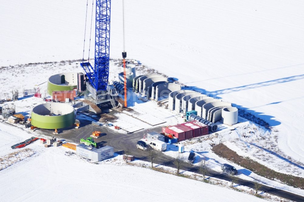 Witzenhausen from the bird's eye view: Wintry snowy Construction site for wind turbine installation in Witzenhausen in the state Hesse, Germany