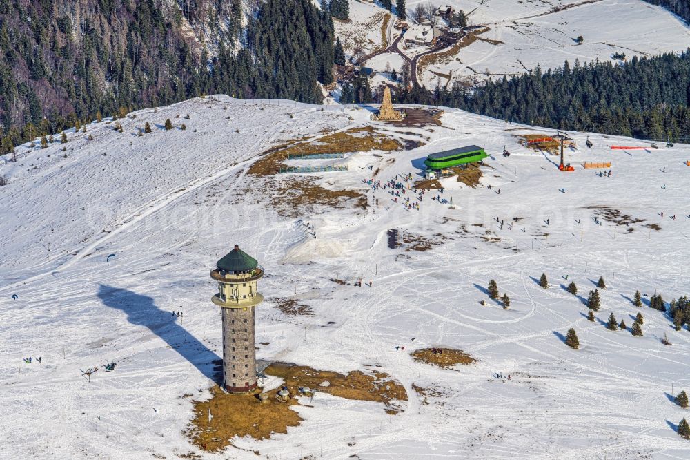 Feldberg (Schwarzwald) from above - Wintry snowy structure of the observation tower Feldbergturm, ehemals Fernmeldeturm heute als Event and Aussichtsturm genutzt in Feldberg (Schwarzwald) in the state Baden-Wurttemberg, Germany