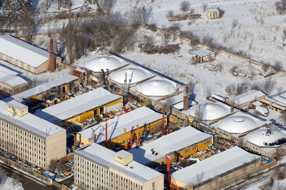 Berlin from the bird's eye view: Wintry snowy site of the depot of the of BORAMTEC Bohr & Rammtechnik Berlin GmbH on Koepenicker Allee in the district Karlshorst in Berlin, Germany