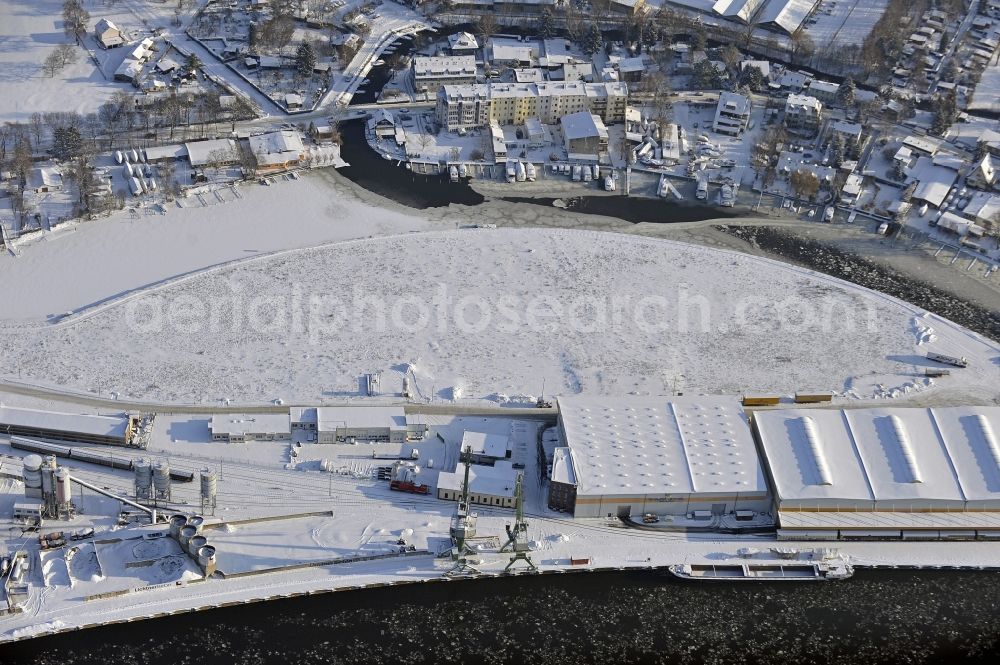 Berlin from above - Wintry snowy wharves and piers with ship loading terminals in the inner harbor Suedhafen on the Havel river in the district Spandau in Berlin, Germany