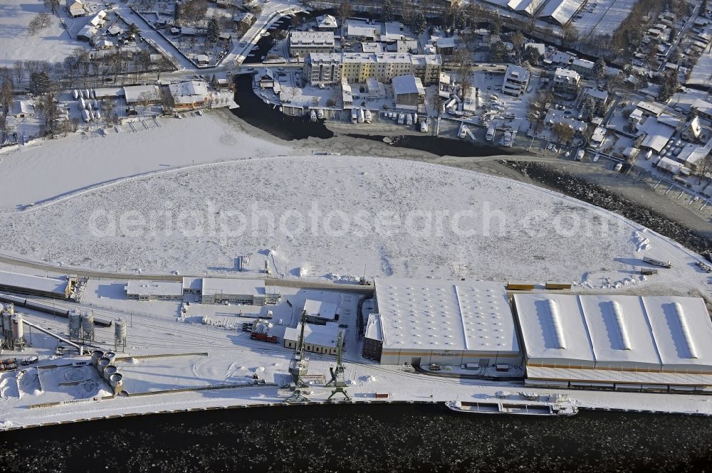 Berlin from the bird's eye view: Wintry snowy wharves and piers with ship loading terminals in the inner harbor Suedhafen on the Havel river in the district Spandau in Berlin, Germany