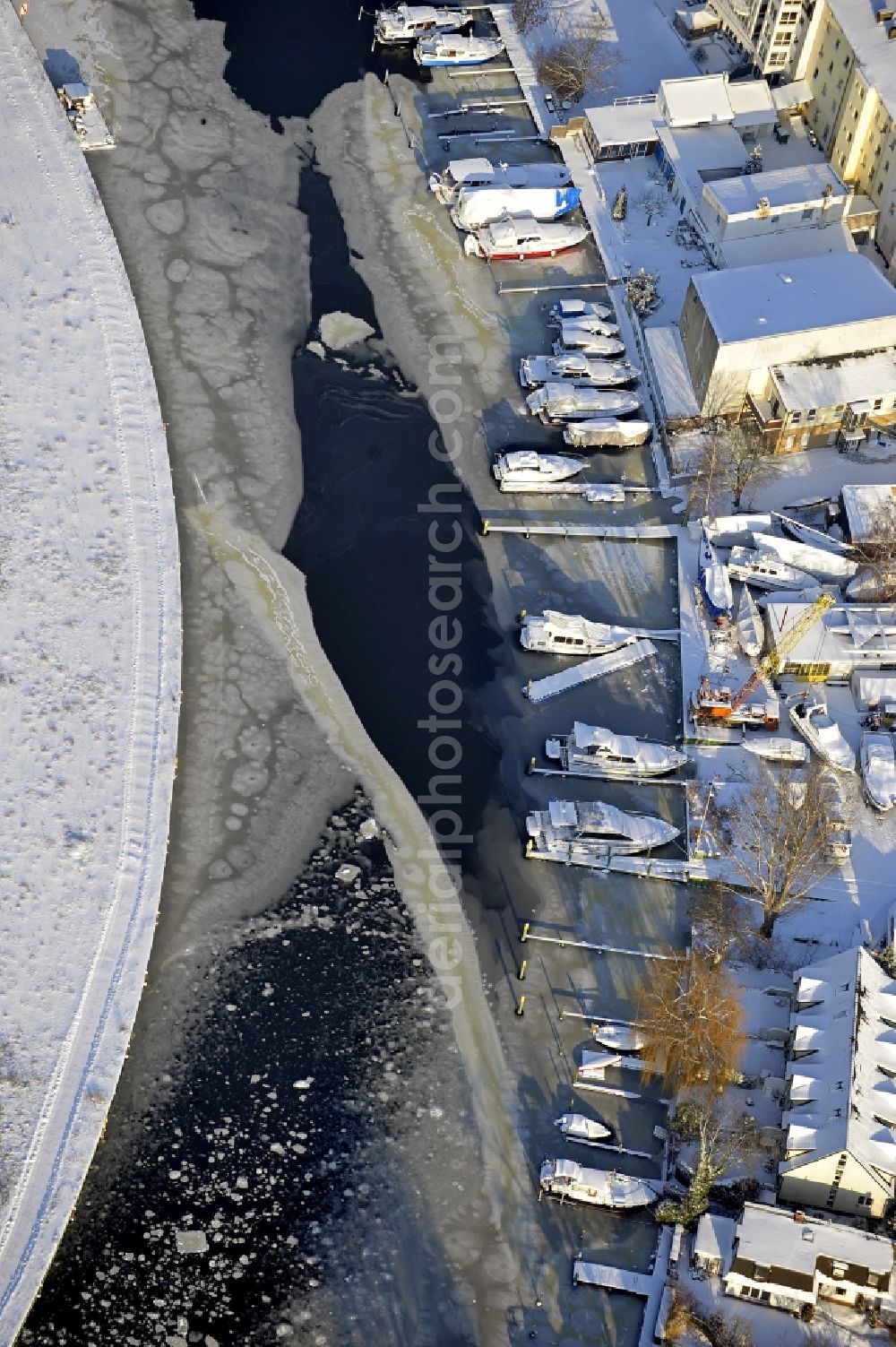 Berlin from the bird's eye view: Wintry snowy wharves and piers with ship loading terminals in the inner harbor Suedhafen on the Havel river in the district Spandau in Berlin, Germany