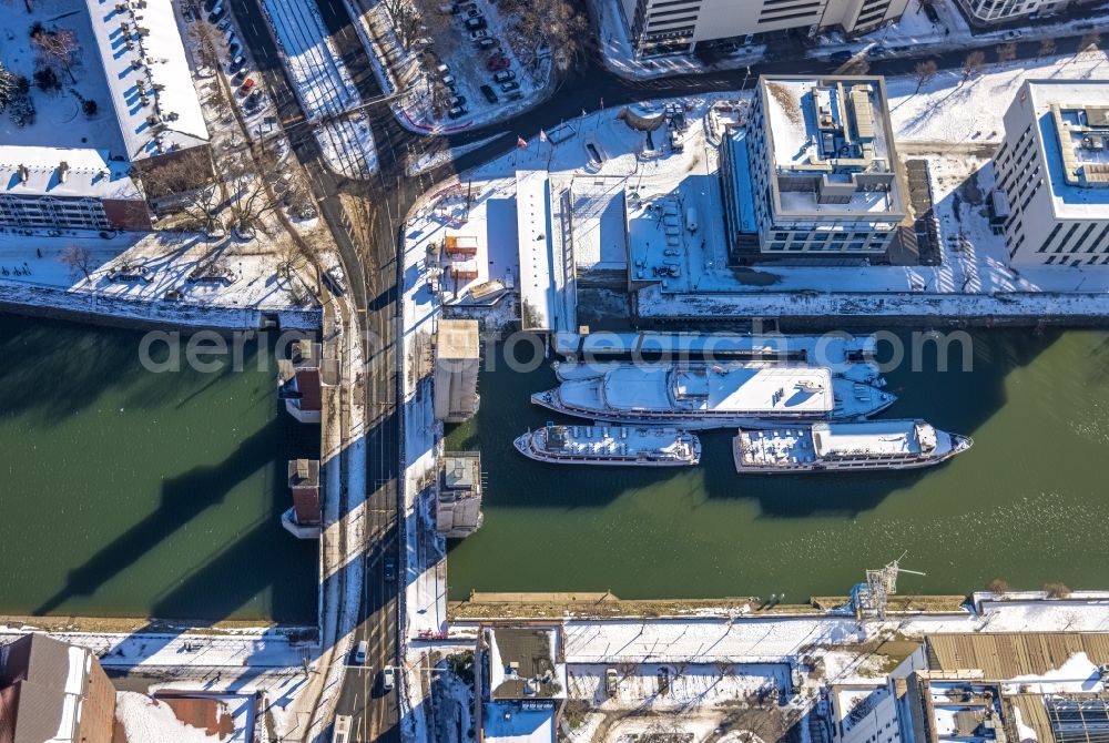 Duisburg from above - Wintry snowy bridge structure - Schwanentorbruecke over the Inner Harbor Canal with covered western towers for renovation in Duisburg in the Ruhr area in the state of North Rhine-Westphalia