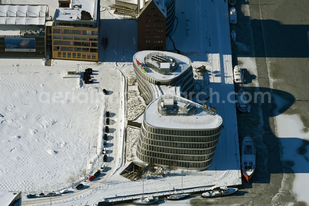 Rostock from above - Wintry snowy office building AIDA Cruises - German Branch of Costa Crociere S.p.A. in Rostock in the state Mecklenburg - Western Pomerania, Germany