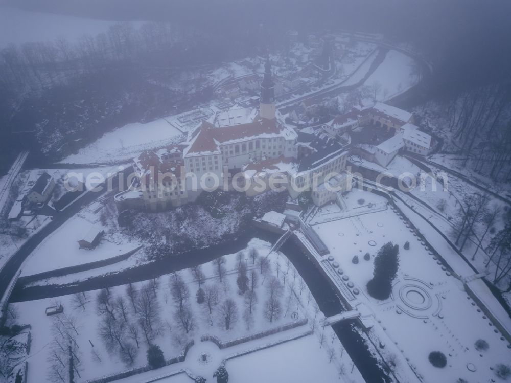 Aerial image Weesenstein - Wintry snowy weesenstein Castle rises on a rocky outcrop above the valley of the Mueglitz about 3 km south of Dohna in the Weesenstein district of the Mueglitztal municipality, in the federal state of Saxony, Germany