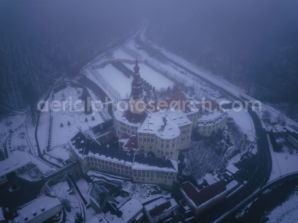 Weesenstein from above - Wintry snowy weesenstein Castle rises on a rocky outcrop above the valley of the Mueglitz about 3 km south of Dohna in the Weesenstein district of the Mueglitztal municipality, in the federal state of Saxony, Germany