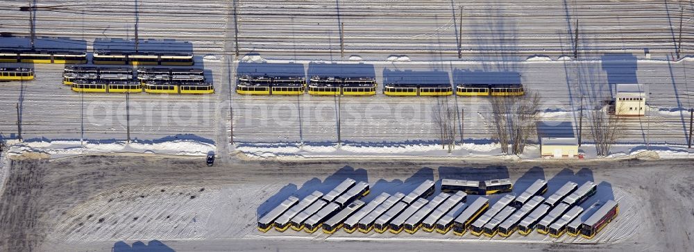 Berlin from the bird's eye view: Wintry snowy bVG bus and train station in the district Lichtenberg in Berlin