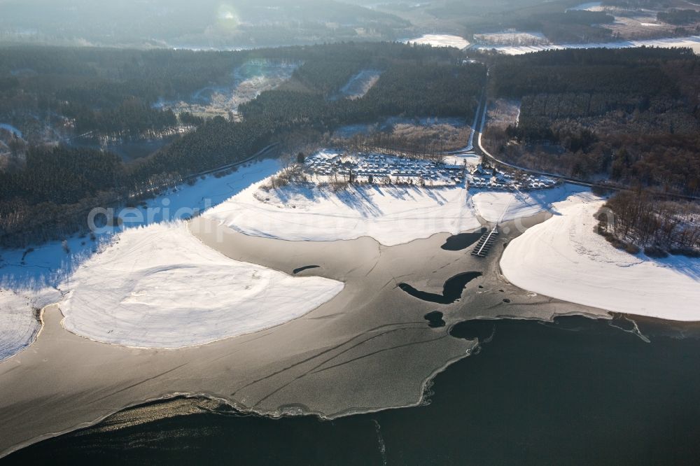 Aerial image Möhnesee - The wintry snowy camping place the Delecke south by caravan on the south shore of the icebound Moehne lake in the district of Koerbecke in Moehnesee in the federal state North Rhine-Westphalia