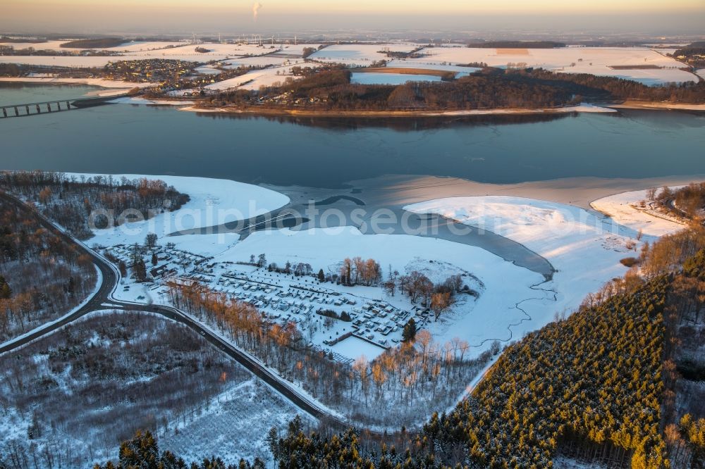 Möhnesee from above - The wintry snowy camping place the Delecke south by caravan on the south shore of the icebound Moehne lake in the district of Koerbecke in Moehnesee in the federal state North Rhine-Westphalia